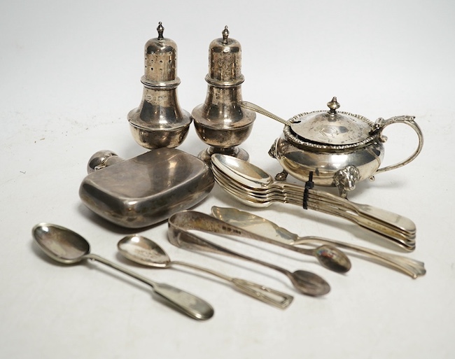 A collection of small silver to include two pepper pots, a mustard pot, a small hip flask, a pair of sugar tongs, a set of five Victorian fiddle pattern teaspoons, two other spoons and a butter knife, 544g gross. Conditi